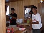 Some of the staff just in front of the kitchen on board the Odyssea I, Sulawesi